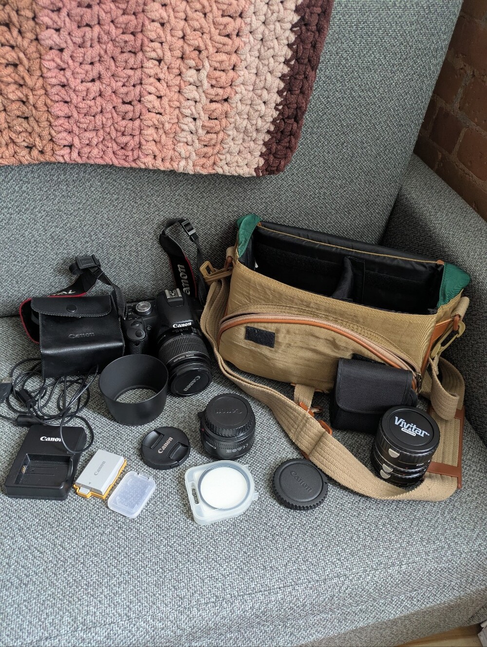 Canon T1i camera sat with zoom lens, 50mm prime, macro extension tubes, and more